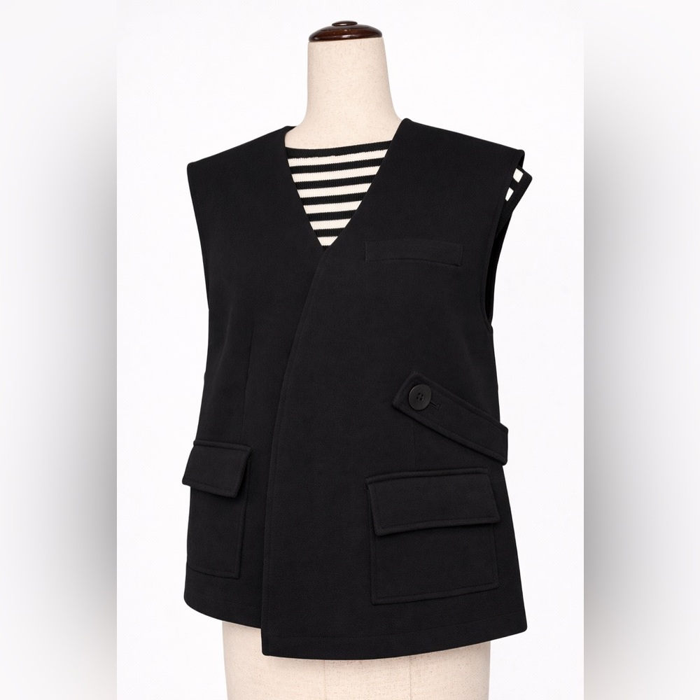 Unique assumetrical vest with pockets and button strap.  Very modern. L